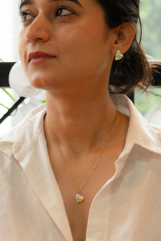 Woman wearing a gold necklace with a heart pendant