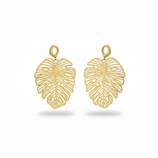 Gold leaf-shaped earrings on a white background